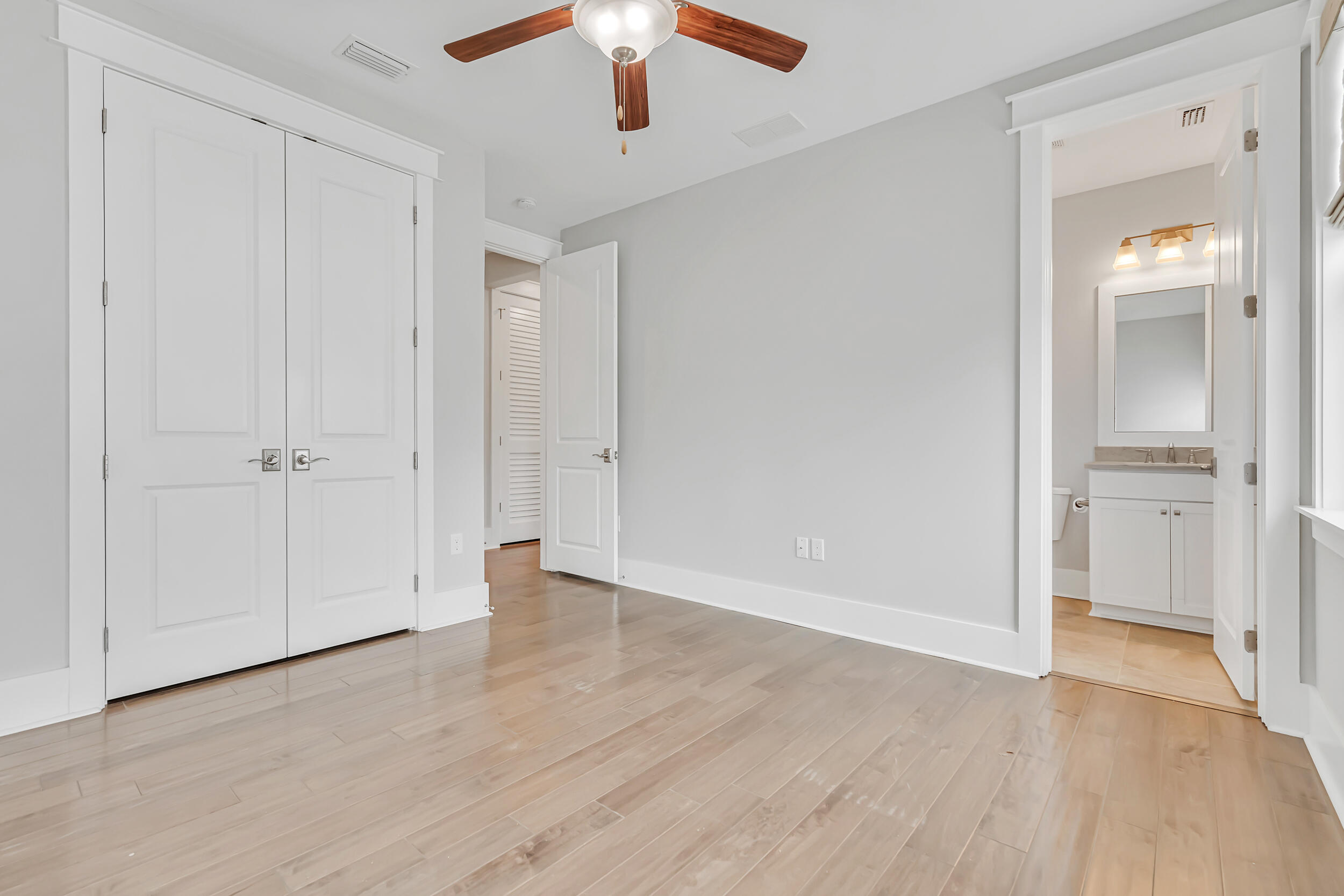 345 Flatwoods Forest Loop Santa Rosa Beach, FL 32459 - Photo 30 of 62 an empty room with wooden floor a ceiling fan