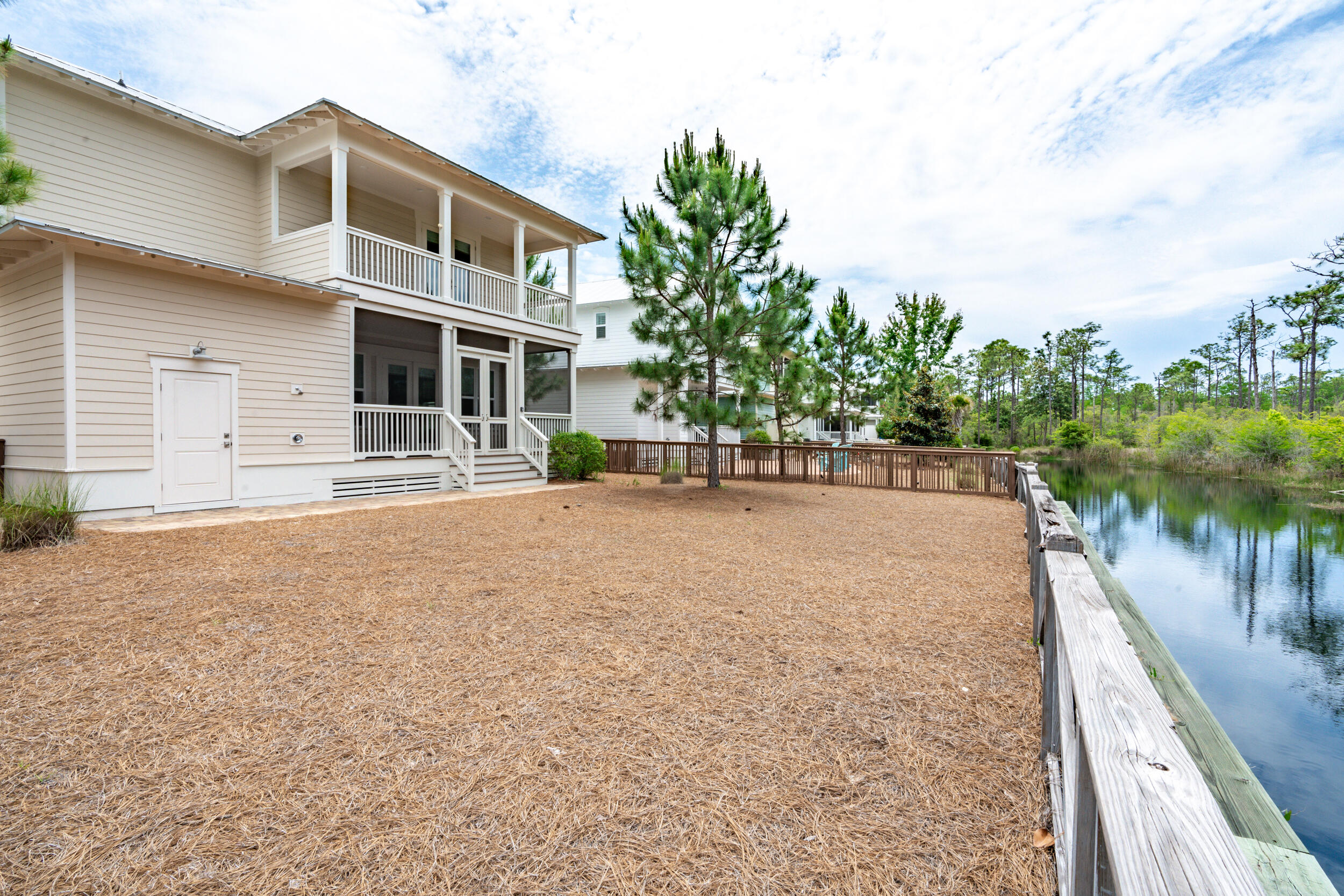 345 Flatwoods Forest Loop Santa Rosa Beach, FL 32459 - Photo 3 of 62 a front view of a house with a yard