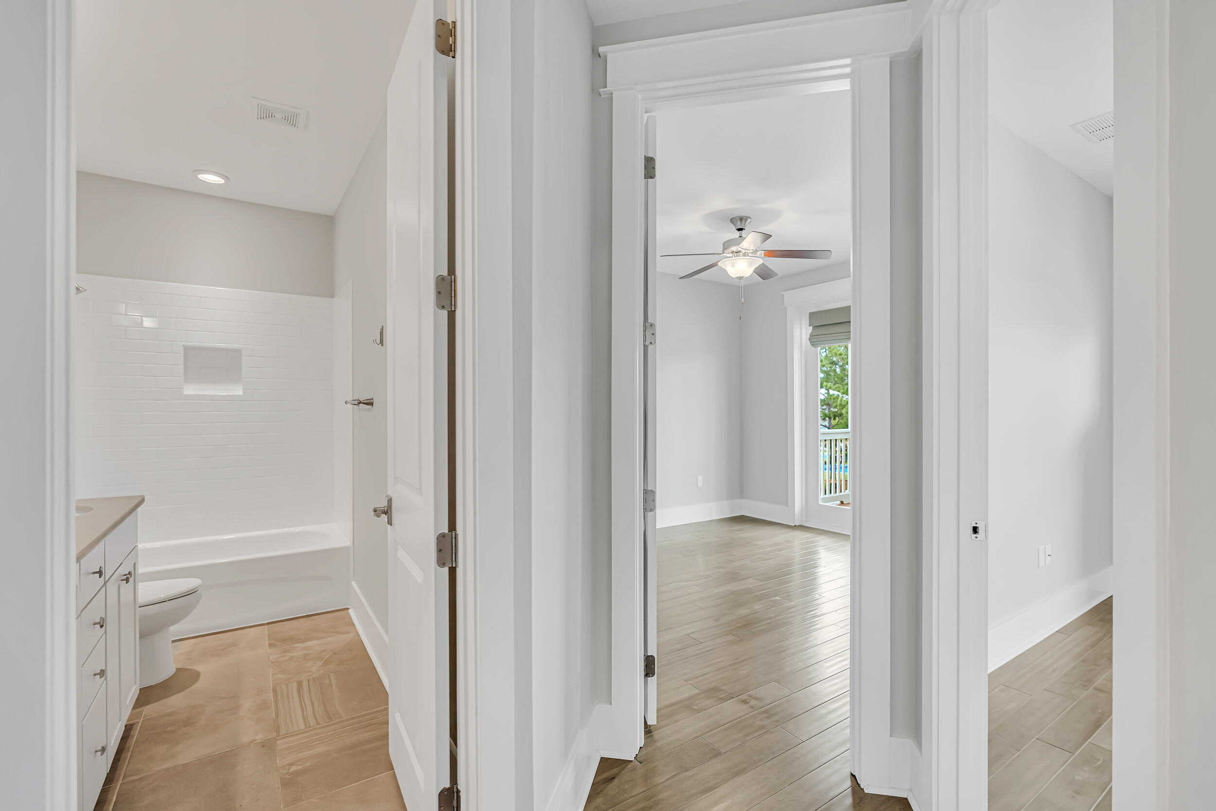 345 Flatwoods Forest Loop Santa Rosa Beach, FL 32459 - Photo 32 of 62 a view of a hallway with wooden floor and a bathroom