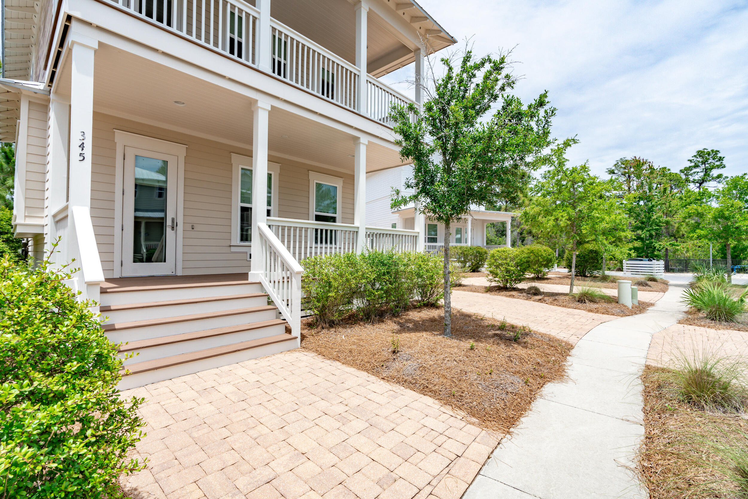 345 Flatwoods Forest Loop Santa Rosa Beach, FL 32459 - Photo 4 of 62 a view of a house with potted plants and a large tree