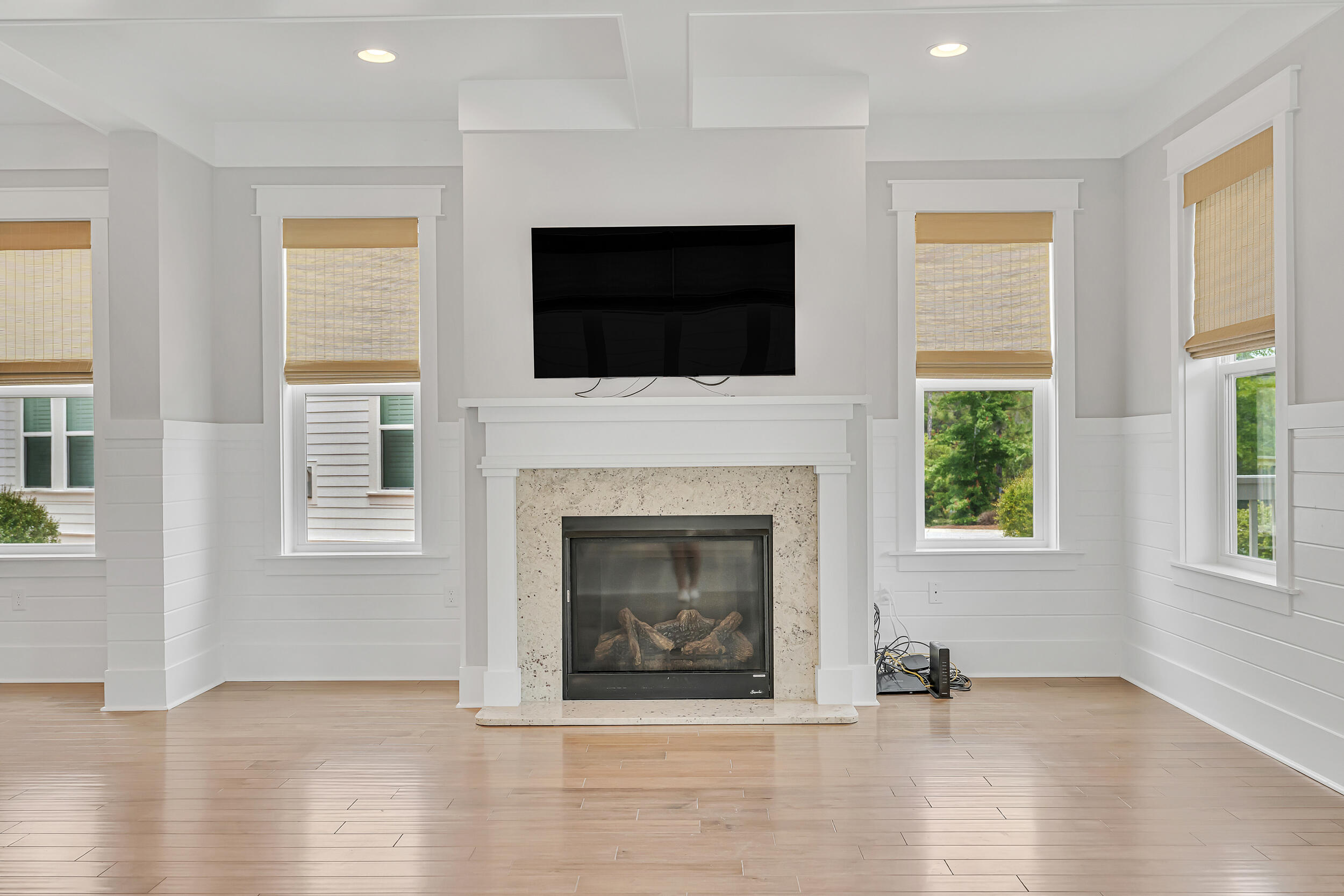 345 Flatwoods Forest Loop Santa Rosa Beach, FL 32459 - Photo 8 of 62 a living room with a fireplace and a flat screen tv