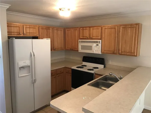 a kitchen with a refrigerator stove and sink