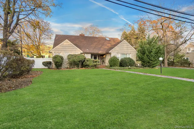 a front view of house with yard and green space