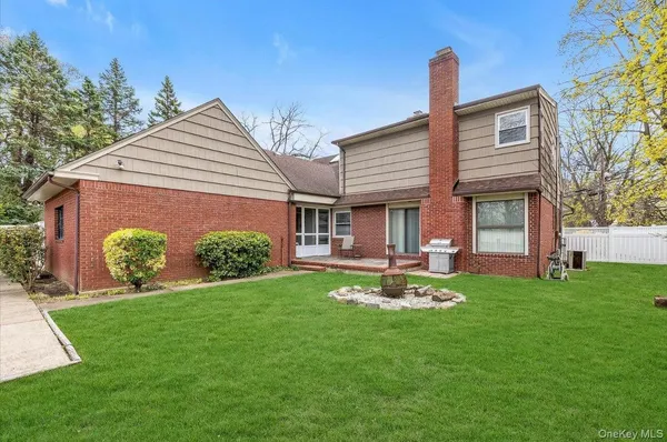 a view of a tennis ground with large trees