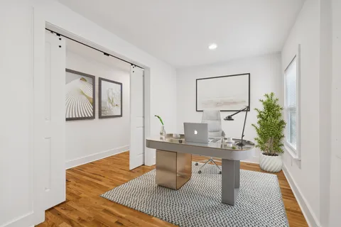 a view of empty room with wooden floor