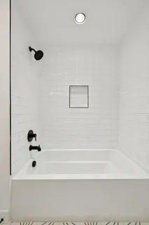 a living room with furniture a flat screen tv and a table