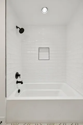 a living room with furniture a flat screen tv and a table