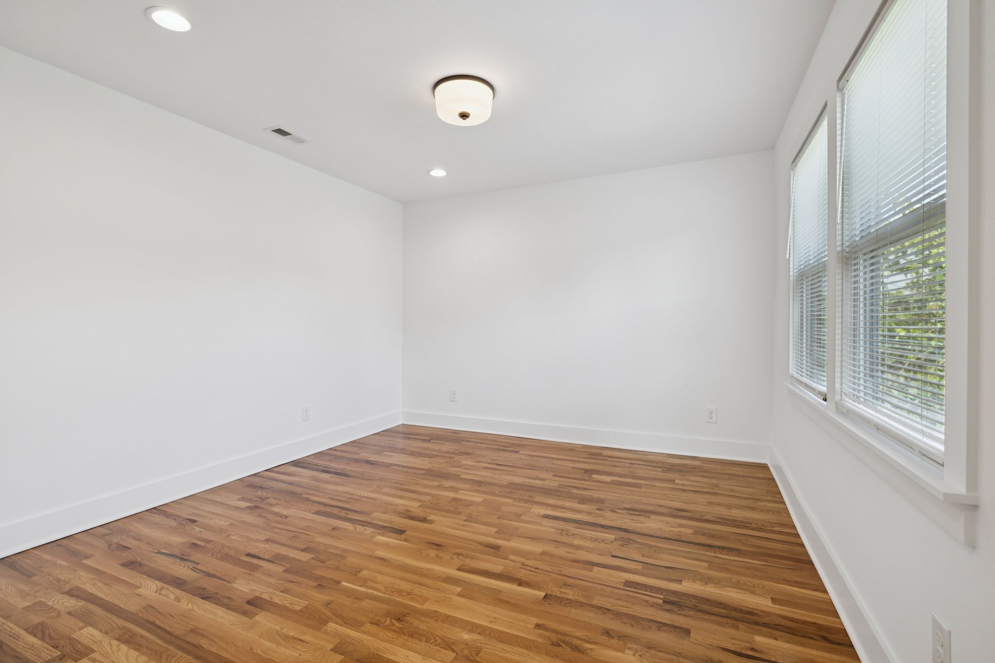 1613 23rd Avenue North Nashville, TN 37208 - Photo 39 of 58 a view of an empty room with wooden floor and a window
