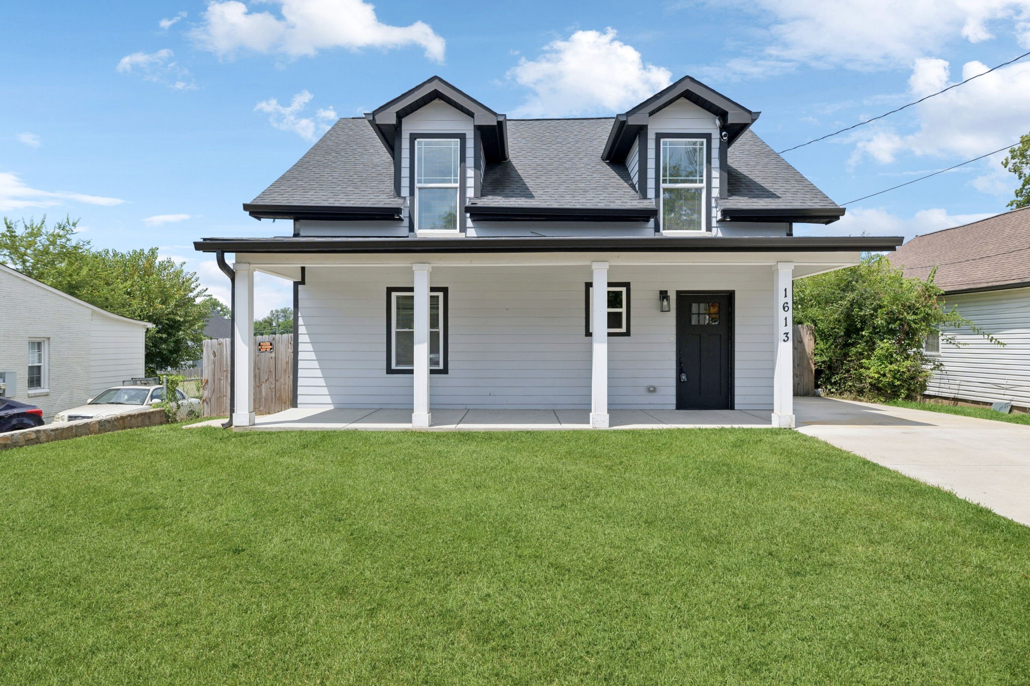 1613 23rd Avenue North Nashville, TN 37208 - Photo 4 of 58 a front view of a house with a yard and garage