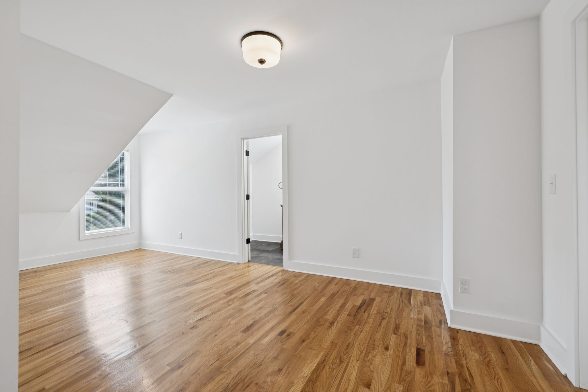 1613 23rd Avenue North Nashville, TN 37208 - Photo 43 of 58 a view of an empty room with wooden floor and a window