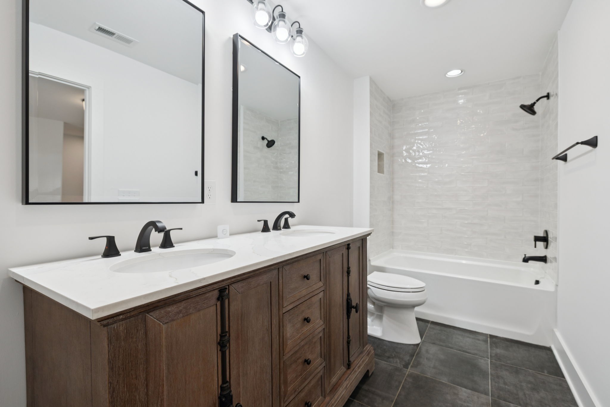 1613 23rd Avenue North Nashville, TN 37208 - Photo 44 of 58 a bathroom with a double vanity sink toilet and shower