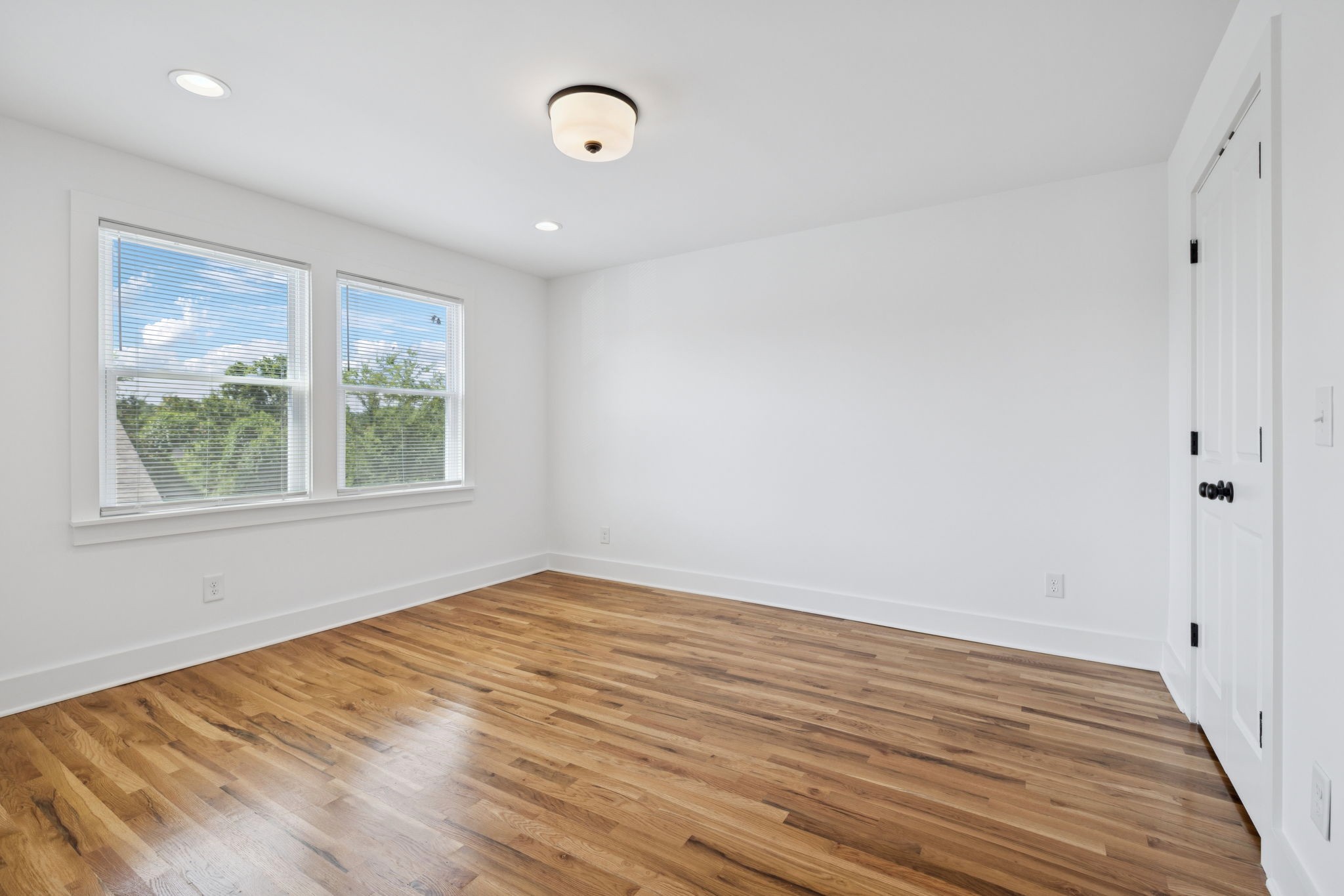 1613 23rd Avenue North Nashville, TN 37208 - Photo 46 of 58 an empty room with wooden floor and windows