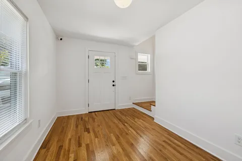 a kitchen with a sink cabinets and wooden floor