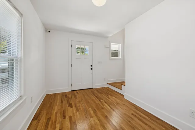 a kitchen with a sink cabinets and wooden floor