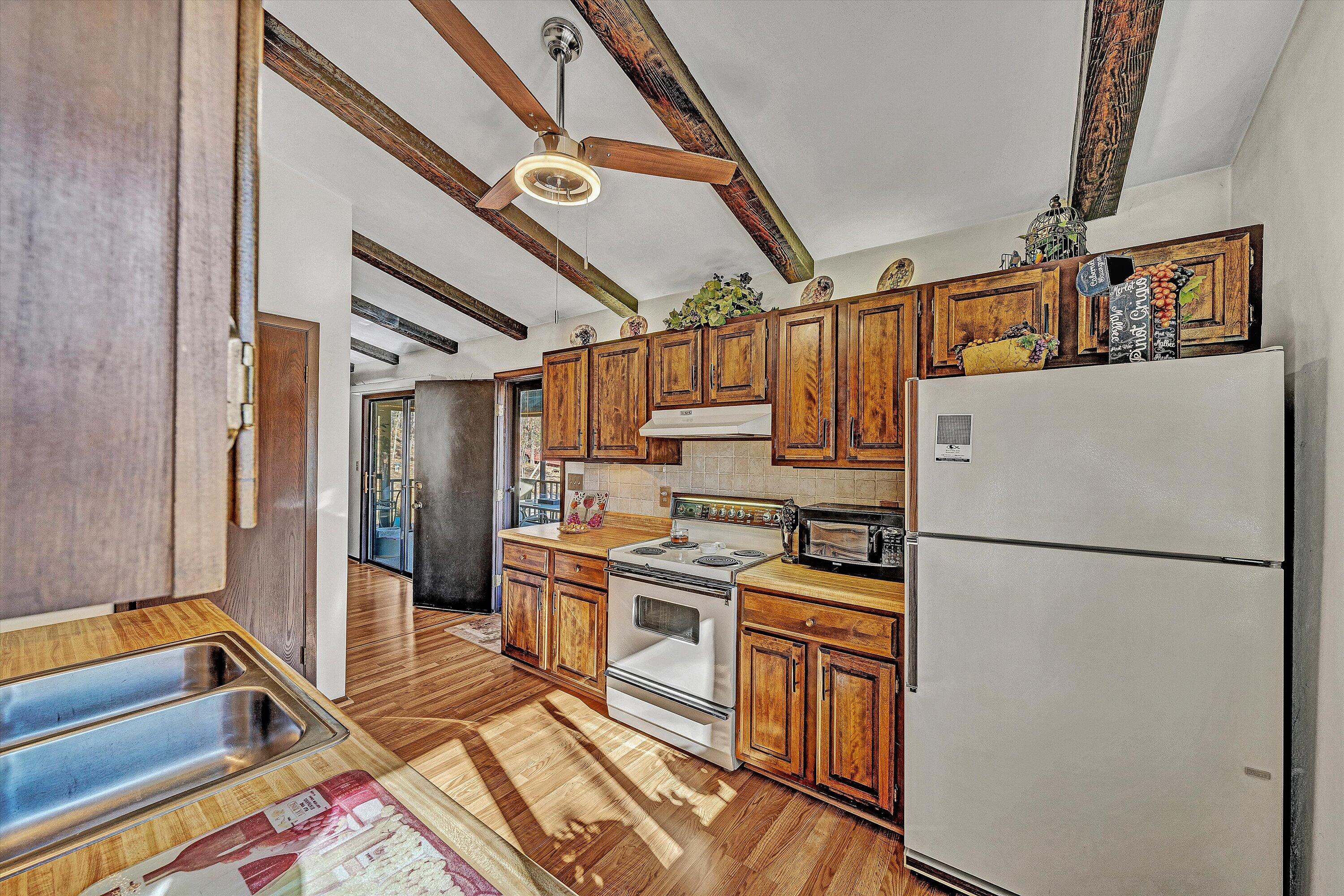 1046 Mountain Pass Road Blue Ridge, VA 24064 - Photo 11 of 25 a kitchen with a refrigerator and a sink
