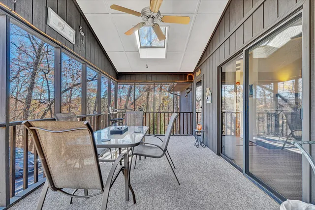 a dining room with furniture a chandelier and wooden floor