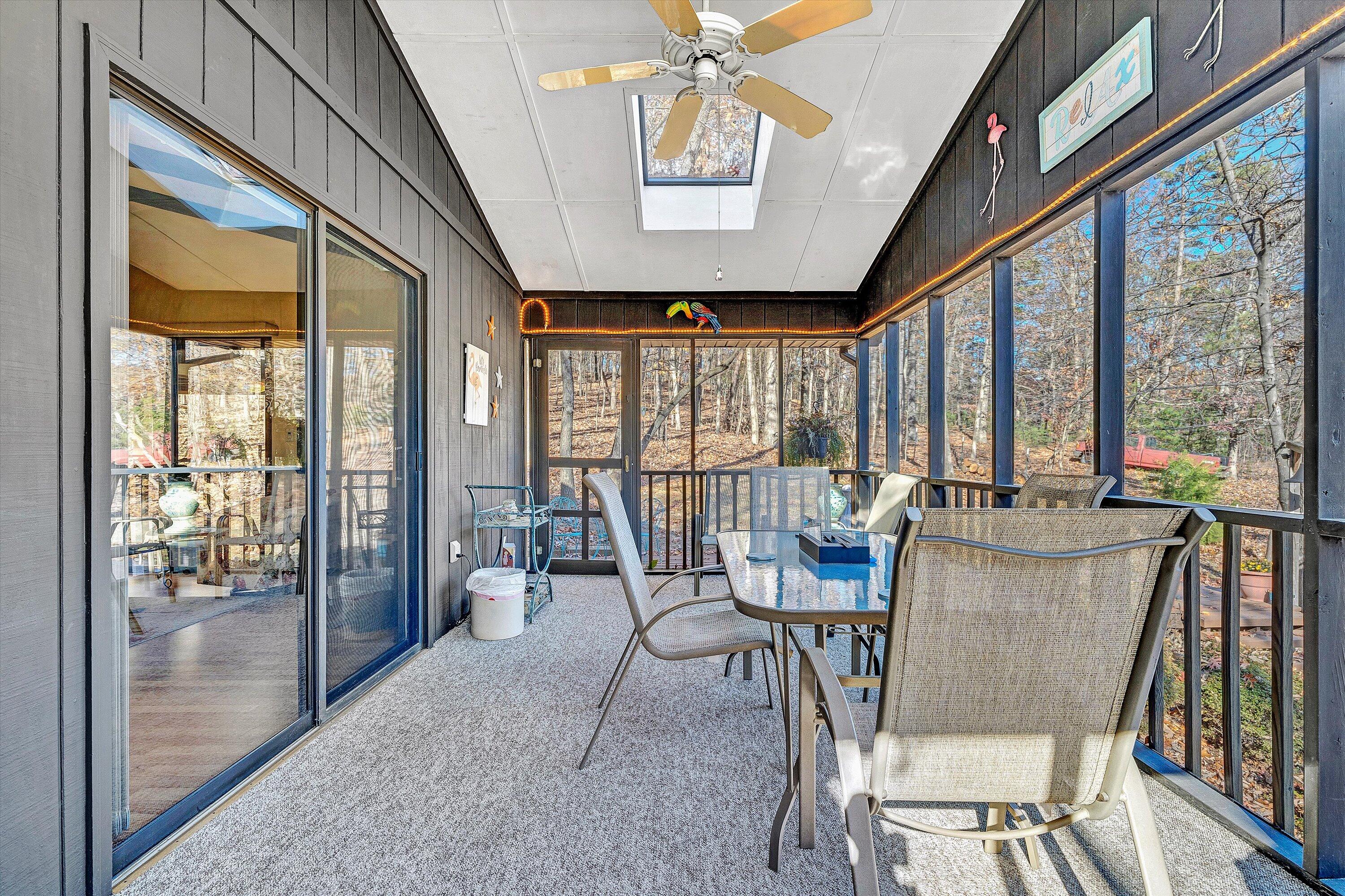 1046 Mountain Pass Road Blue Ridge, VA 24064 - Photo 12 of 25 a view of a dining room with furniture large windows and wooden floor