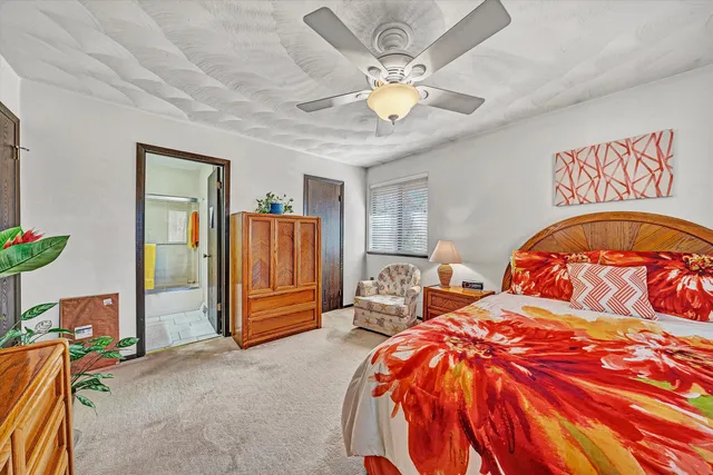 a bed room with a bed and a chair