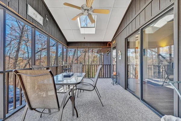 a dining room with furniture a chandelier and wooden floor