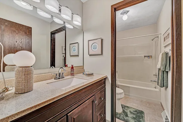 a bathroom with a sink a mirror and a shower