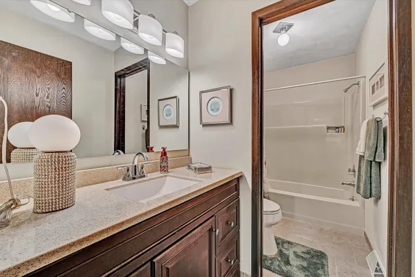 a bathroom with a sink a mirror and a shower