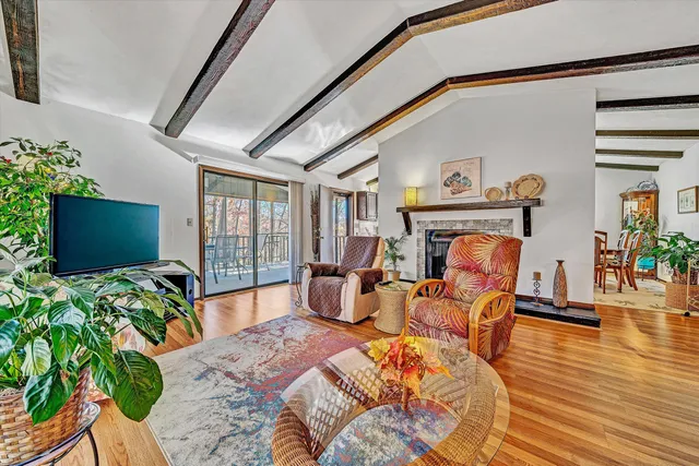 a bedroom with furniture and a large window