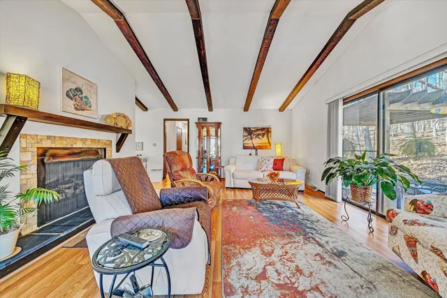 a living room with furniture and a floor to ceiling window