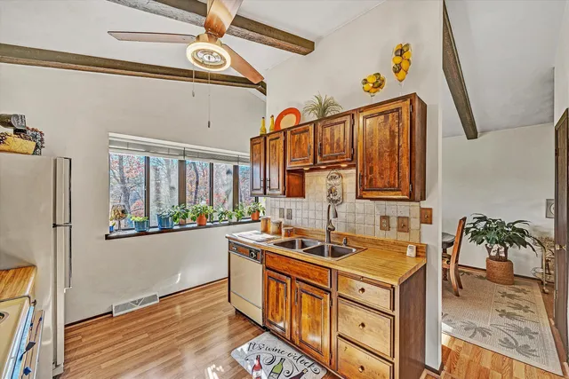 a kitchen with stainless steel appliances granite countertop a sink stove and cabinets