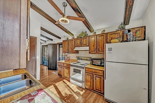 a kitchen with a refrigerator and a sink