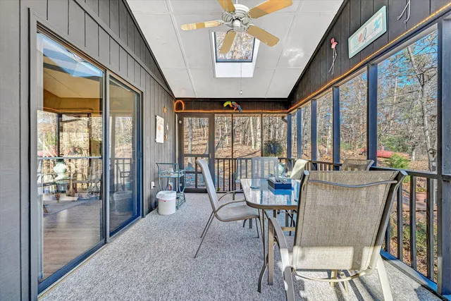 a view of a dining room with furniture large windows and wooden floor