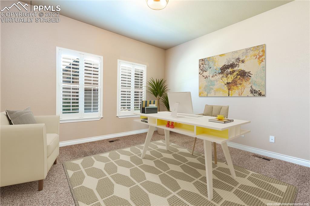 2361 Conservatory Point Colorado Springs, CO 80918 - Photo 12 of 50 a living room with a large window and a table