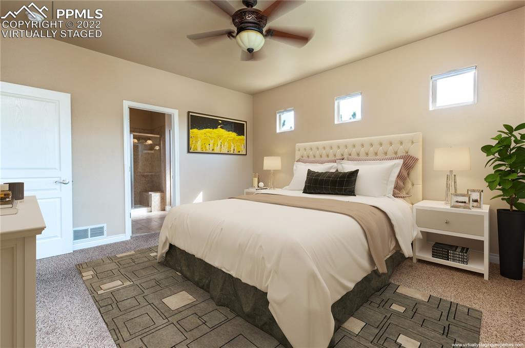 2361 Conservatory Point Colorado Springs, CO 80918 - Photo 16 of 50 a bedroom with a bed and a chandelier