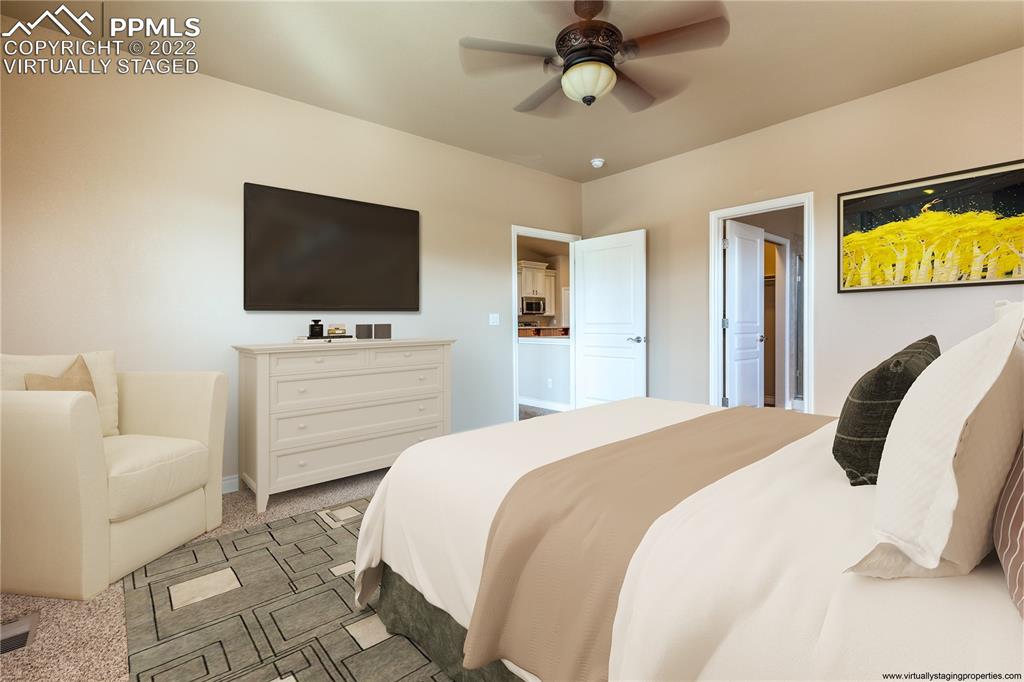 2361 Conservatory Point Colorado Springs, CO 80918 - Photo 17 of 50 a bedroom with a bed and a flat screen tv