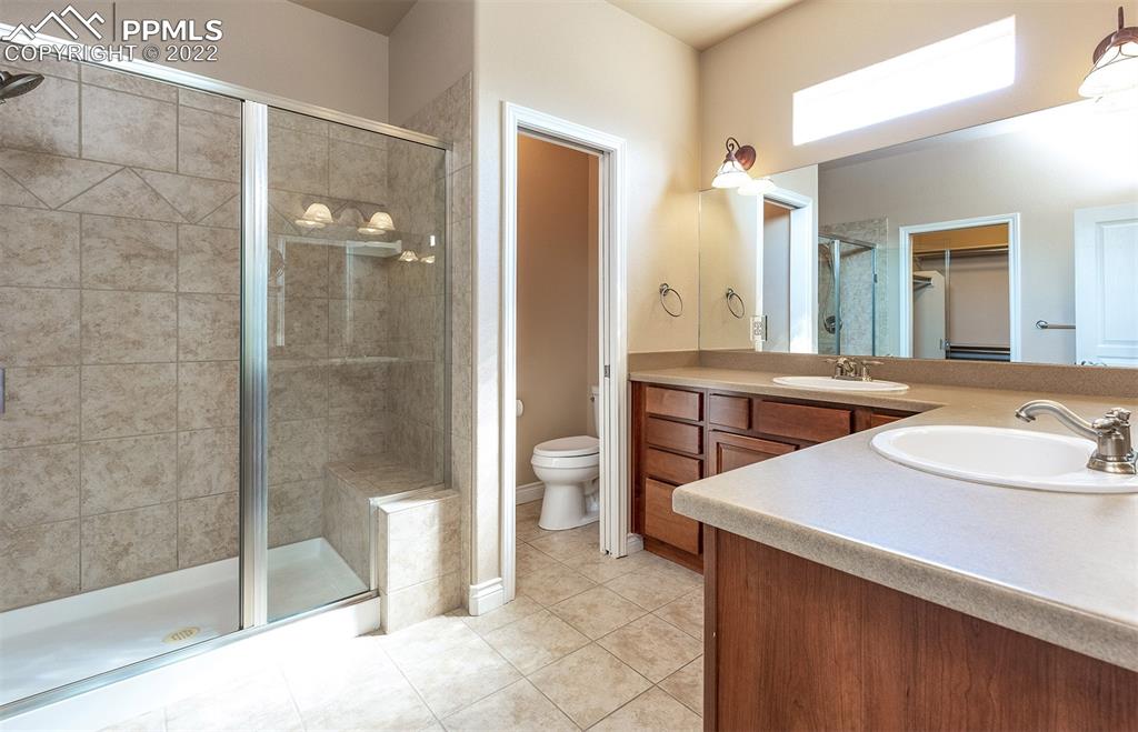 2361 Conservatory Point Colorado Springs, CO 80918 - Photo 18 of 50 a bathroom with a sink a toilet and shower