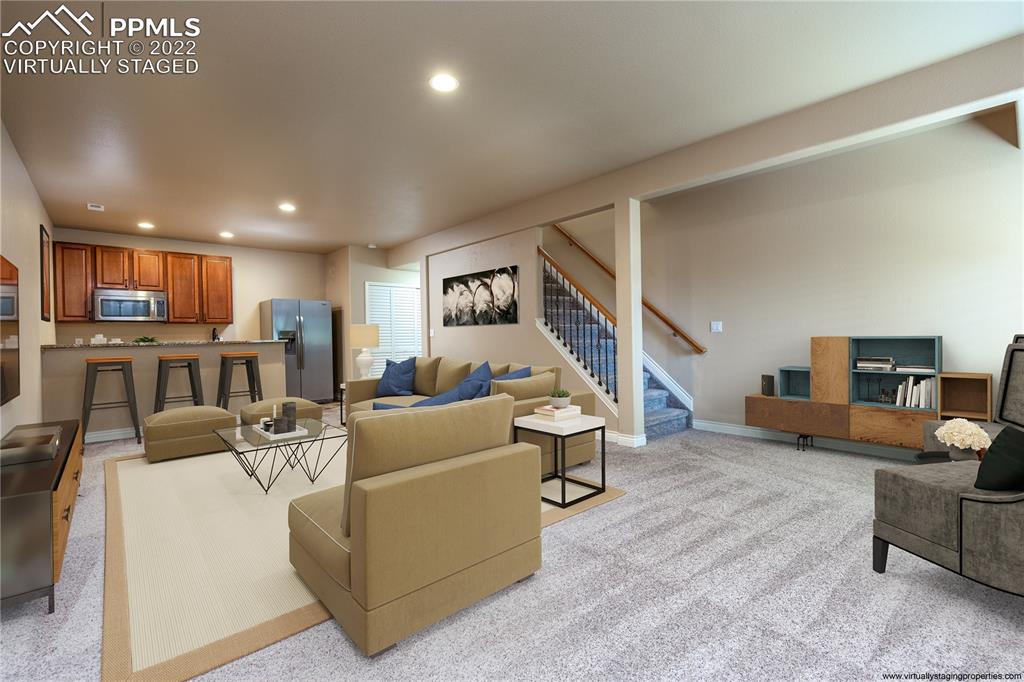 2361 Conservatory Point Colorado Springs, CO 80918 - Photo 21 of 50 a living room with furniture and a kitchen view