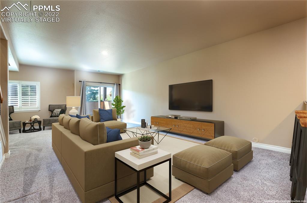 2361 Conservatory Point Colorado Springs, CO 80918 - Photo 23 of 50 a living room with furniture and a flat screen tv