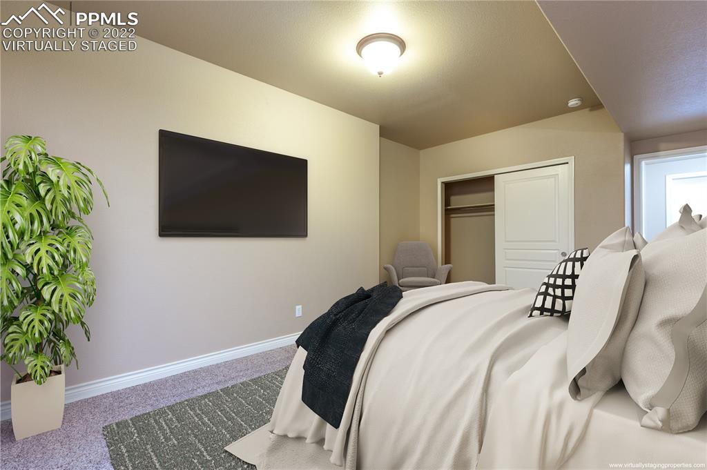 2361 Conservatory Point Colorado Springs, CO 80918 - Photo 25 of 50 a bedroom with a bed and a potted plant
