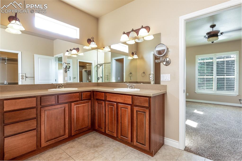 2361 Conservatory Point Colorado Springs, CO 80918 - Photo 39 of 50 a spacious bathroom with a sink and a large mirror