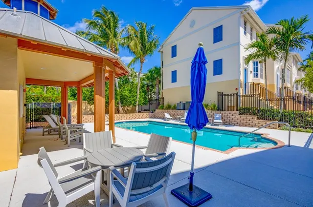 a view of a patio with a table and chairs