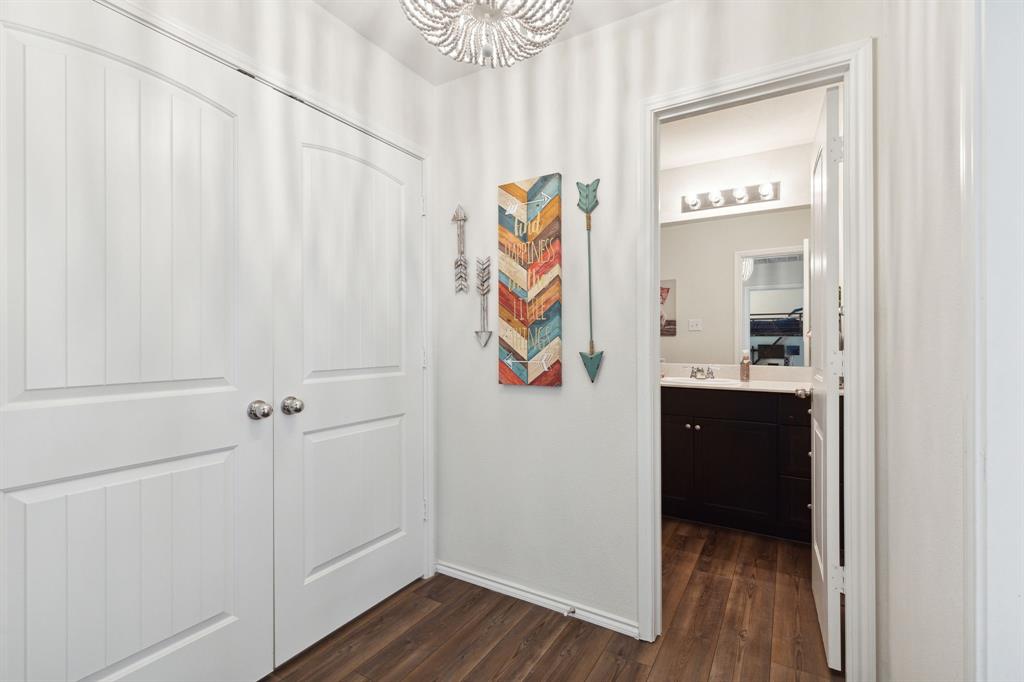 5513 Berea Street Forney, TX 75126 - Photo 15 of 29 The hallway with access to the bathroom and the laundry closet.