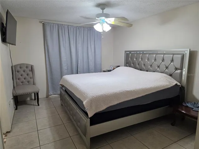 a bedroom with a bed and a chair