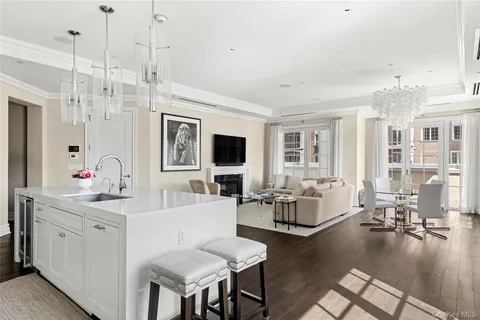 a living room with fireplace furniture and a wooden floor