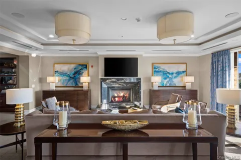 a living room with fireplace furniture and a chandelier