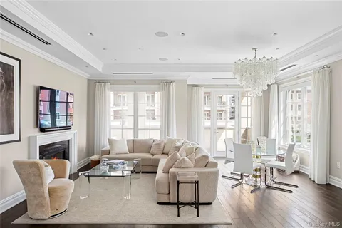 a living room with fireplace furniture and a large window