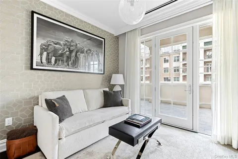 a living room with furniture and a floor to ceiling window