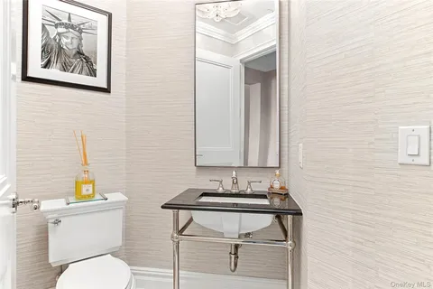 a bathroom with a toilet a sink and mirror