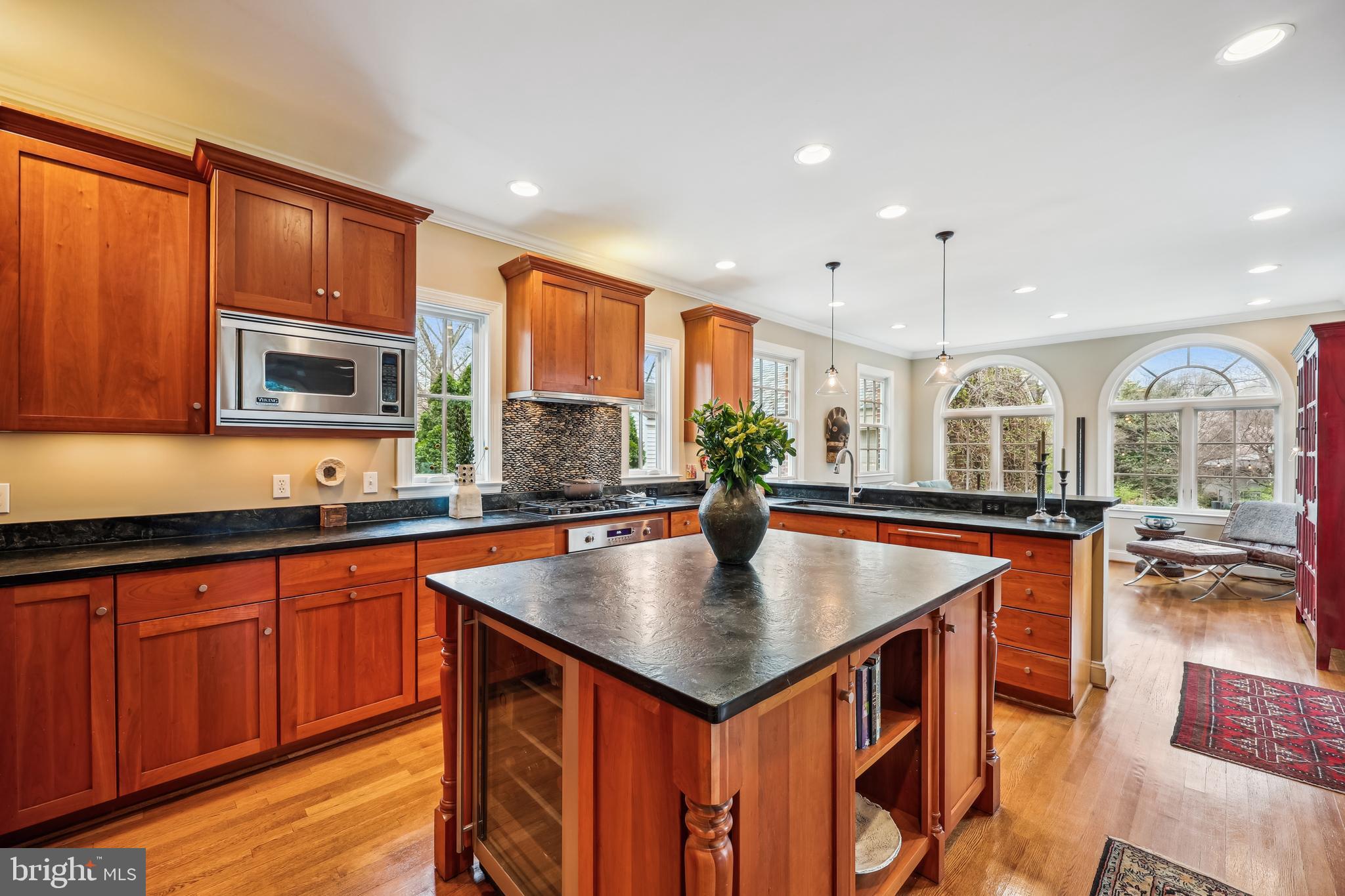 9014 Fairview Road Silver Spring, MD 20910 - Photo 18 of 94 a kitchen with stainless steel appliances granite countertop a sink a stove counter space and a large window