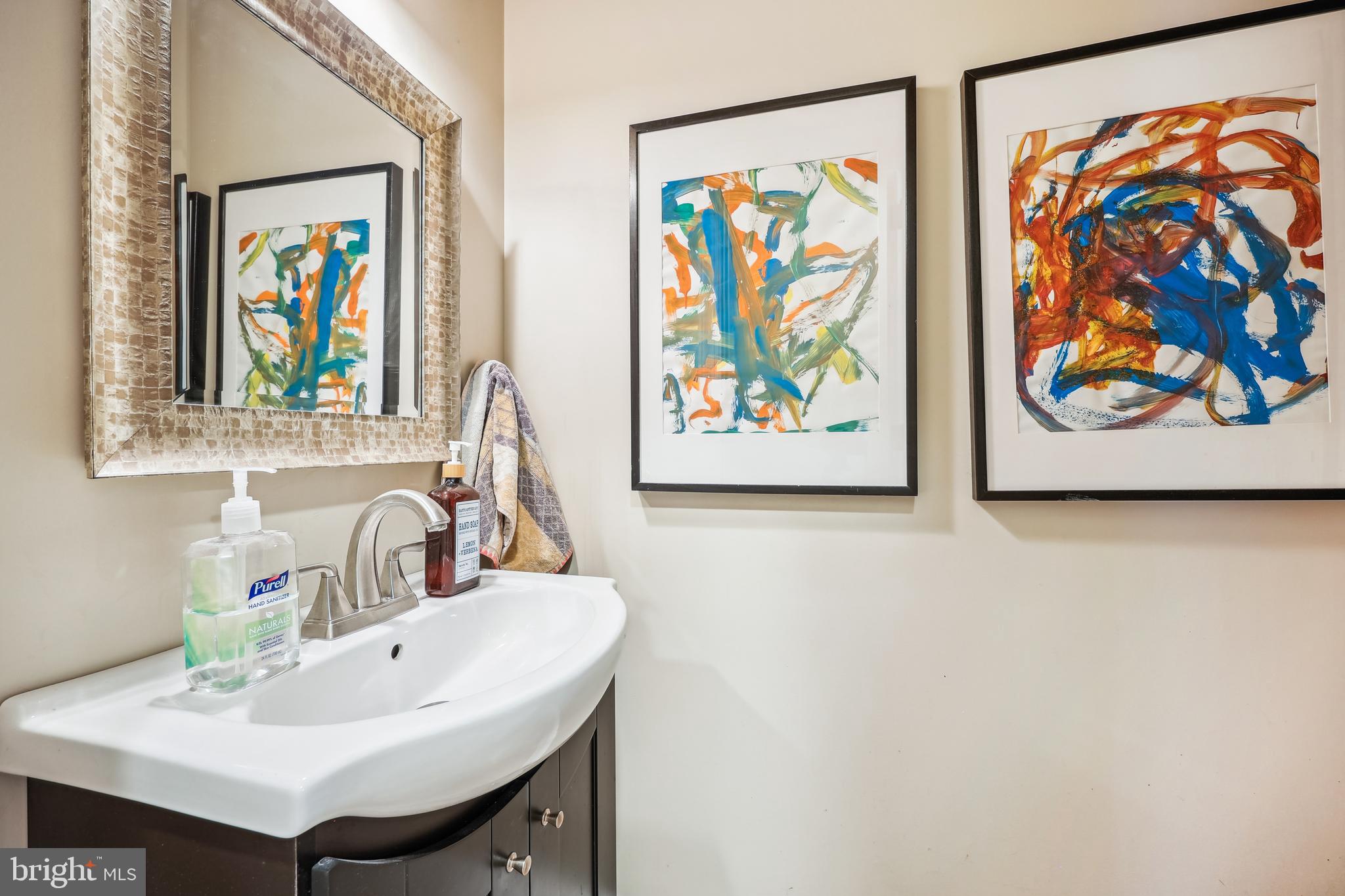 9014 Fairview Road Silver Spring, MD 20910 - Photo 27 of 94 a sink with a painting on the wall and a painting on the wall