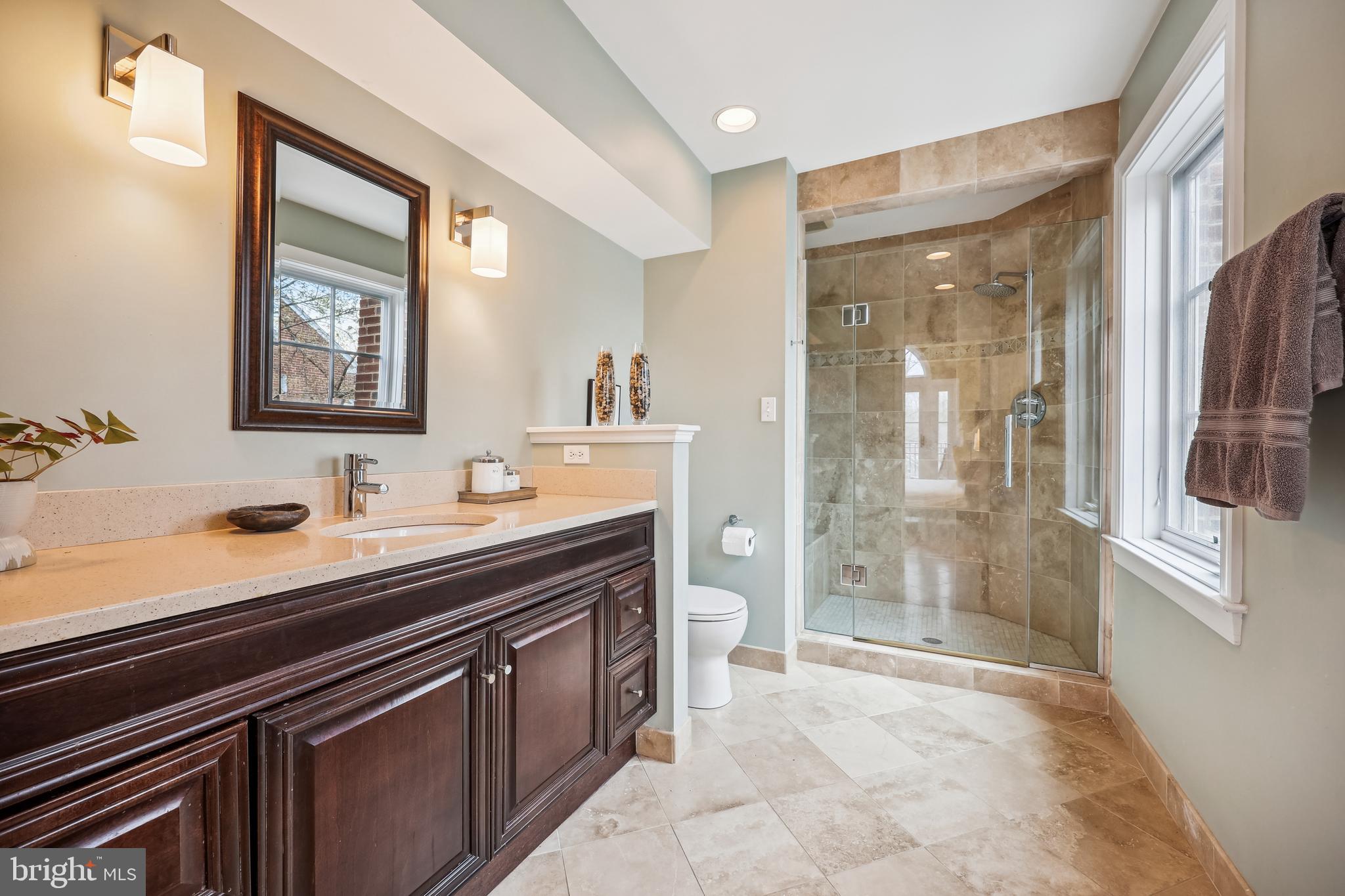 9014 Fairview Road Silver Spring, MD 20910 - Photo 37 of 94 a spacious bathroom with a shower sink and mirror