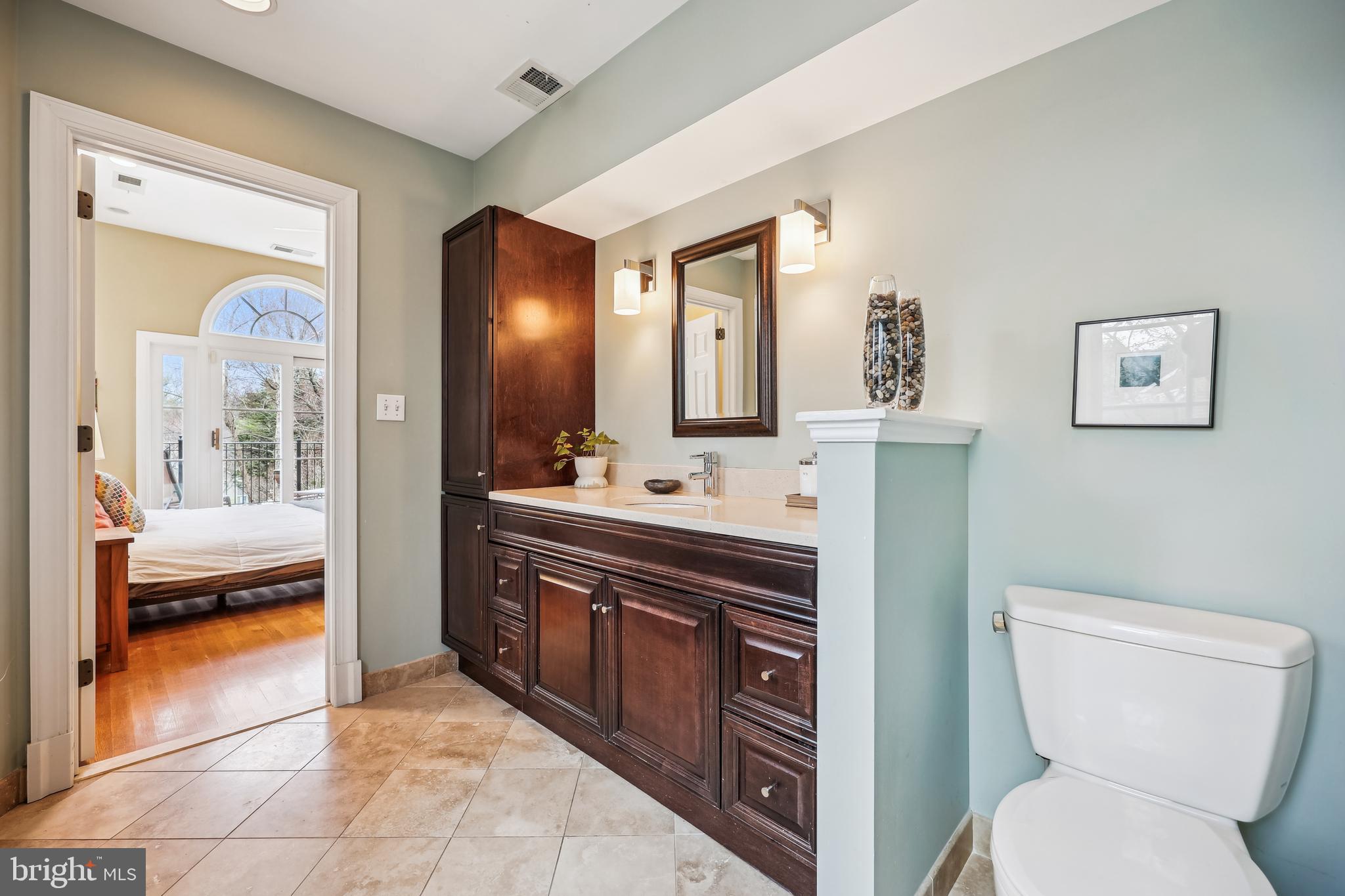 9014 Fairview Road Silver Spring, MD 20910 - Photo 38 of 94 a bathroom with a toilet sink vanity and mirror